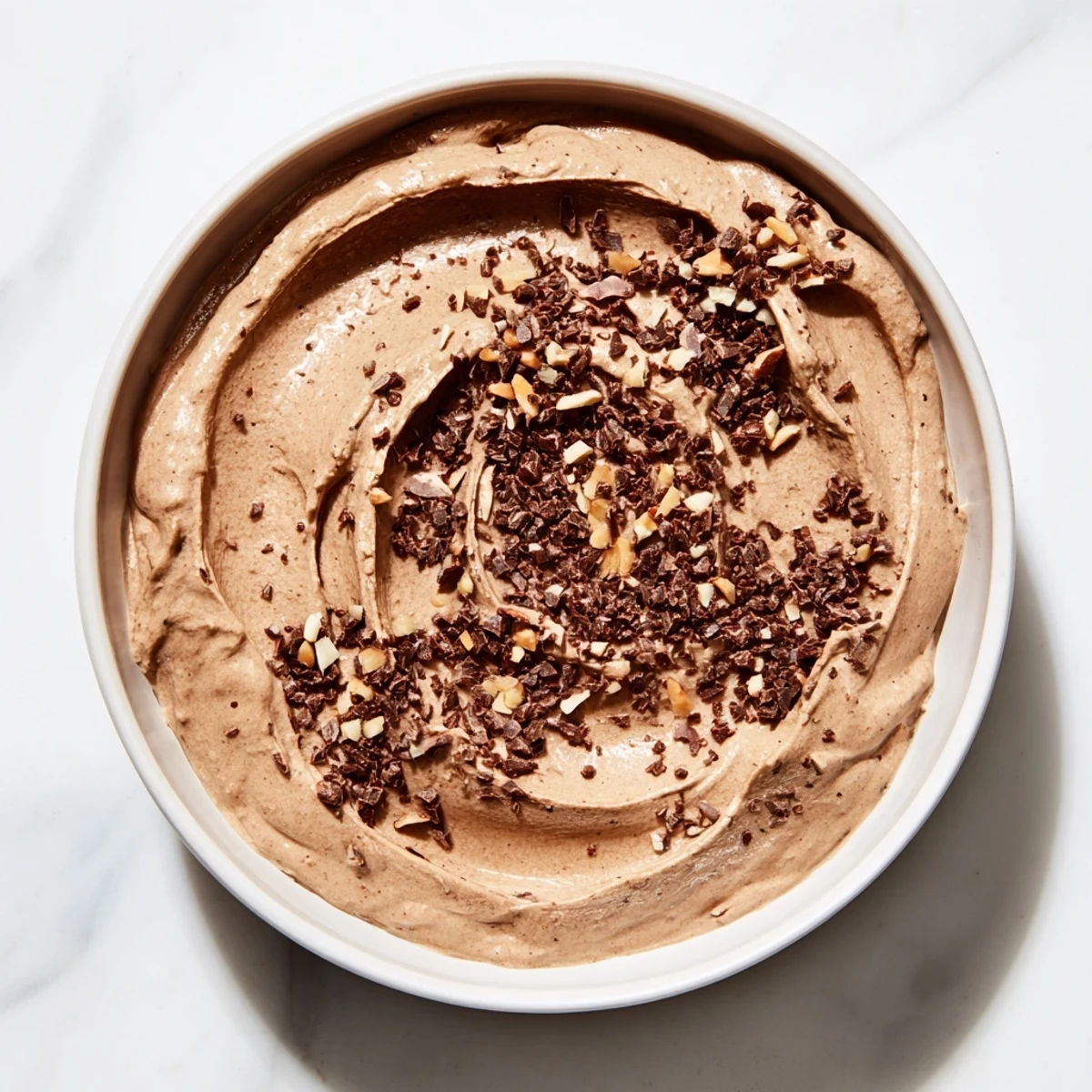 A close-up of the flavorful Chestnut Cream Cheese Spread, ideal for crackers, garnished with hazelnuts.