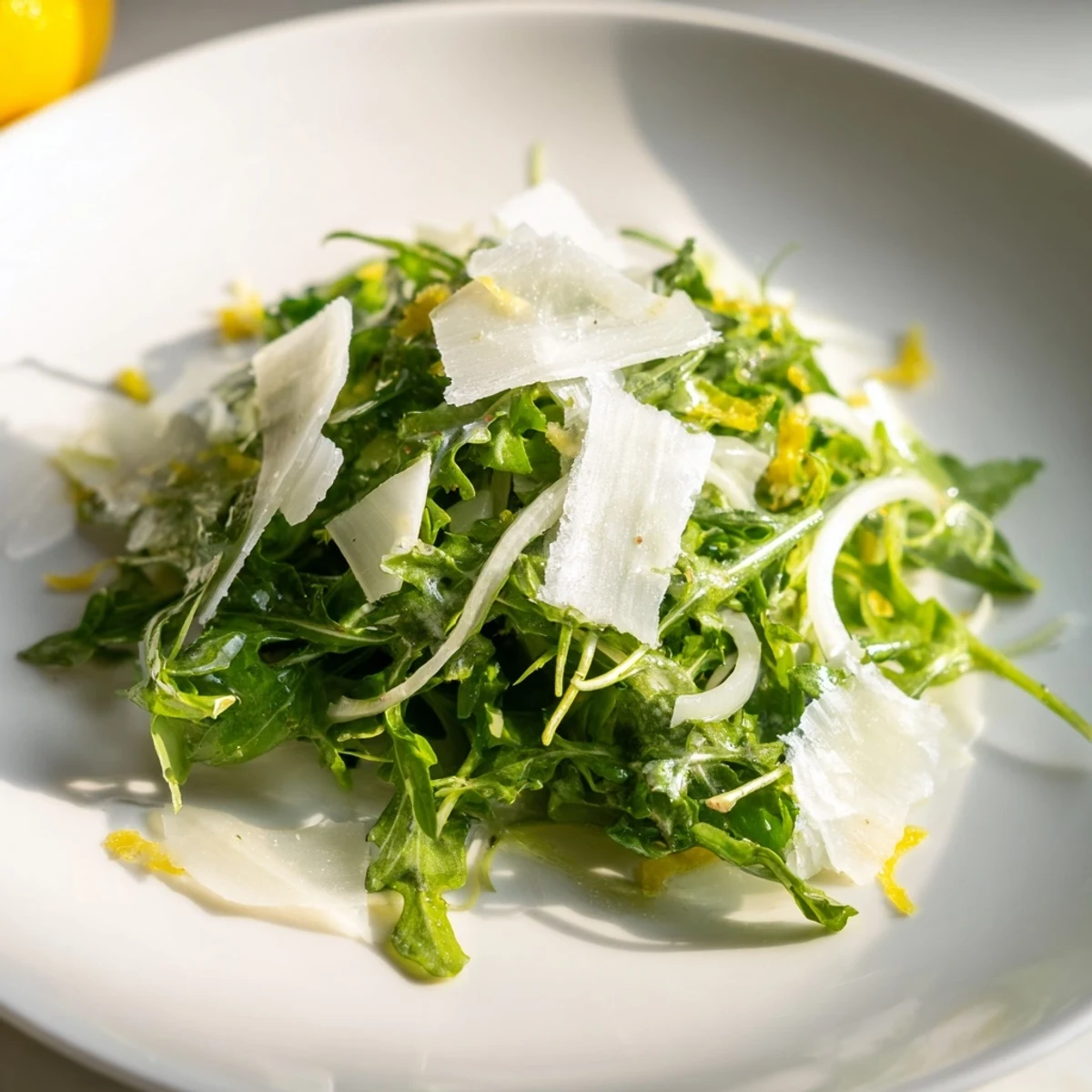 Tangy arugula salad with lemon dressing, ready to be tossed and enjoyed.
