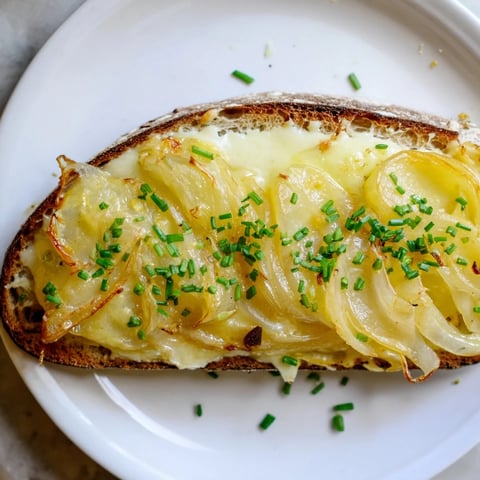 Golden, bubbly Cheesy Onion Tartine, a warm and inviting open-faced sandwich with melted cheese.