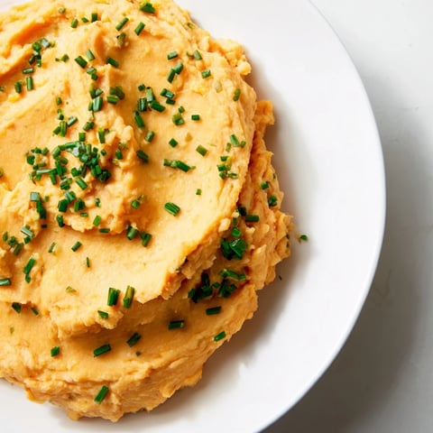 Creamy Sweet Potato & Celeriac Mash, a smooth, vibrant side dish with fresh herbs.