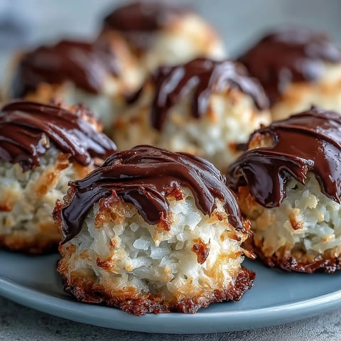 Golden-brown Vegan Coconut Macaroons with Dark Chocolate Drizzle glistening on a cooling rack.