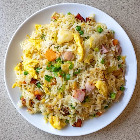 Plate of rice with vegetables and meat.