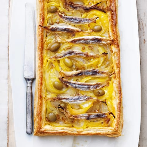 Warm, flaky Classic Onion Pissaladière Tart, a savory appetizer brimming with caramelized onions.