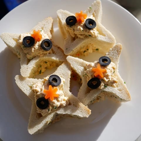 Freshly made Mini Starfish Sandwiches arranged beautifully on a serving platter, a delightful appetizer.
