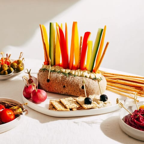 This Autumn Hedgehog Dip Platter showcases a charming arrangement of dips and fresh veggie dippers.