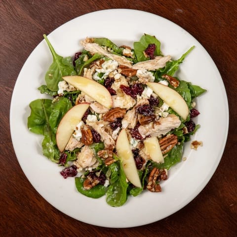 This Chicken and Apple Winter Salad features crunchy pecans, mixed greens, and a tangy cider dressing.