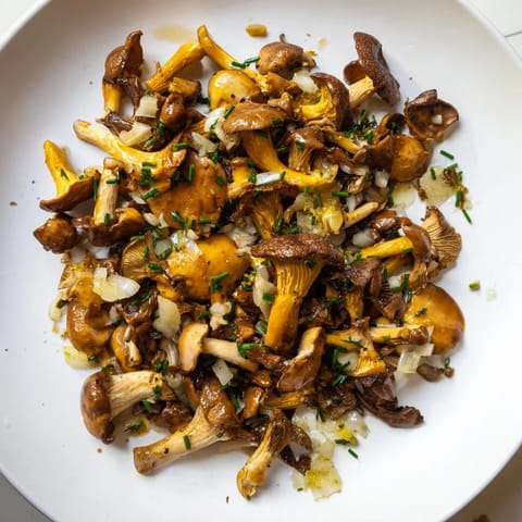 Delicious Enchanted Forest Mushrooms sizzling in a pan, infused with garlic and white wine, ready to serve.