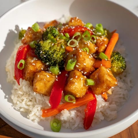 A delicious close-up of Honey Garlic Tofu Bowls with a sticky, savory honey-garlic glaze.