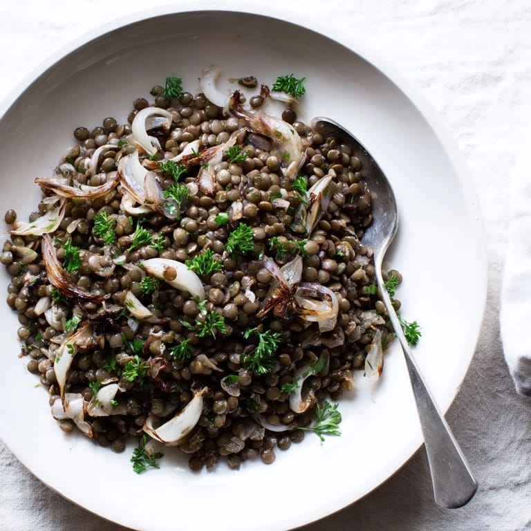 Enjoy a healthy serving of fresh warm green lentil salad, perfect for a light lunch.
