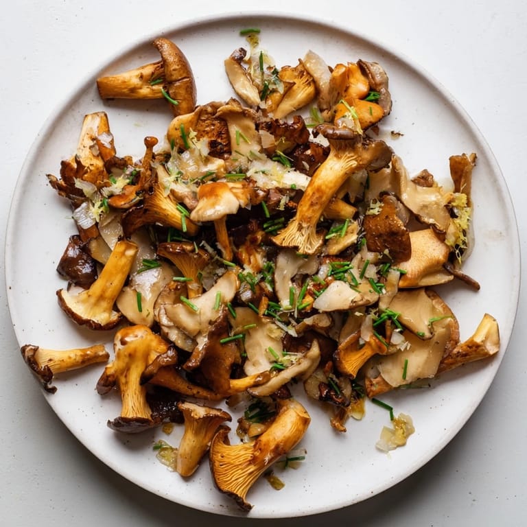 Vibrant image shows finished Enchanted Forest Mushrooms, a French-inspired side, garnished with fresh chives.