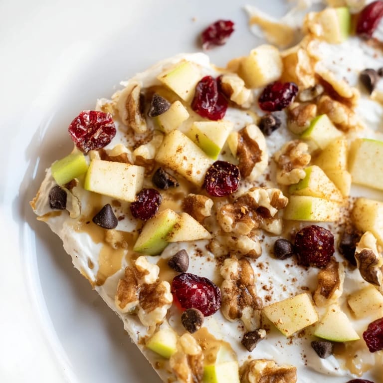 Frozen Apple Cinnamon Yogurt Bark offering a cool, creamy treat, beautifully layered with crunchy toppings.