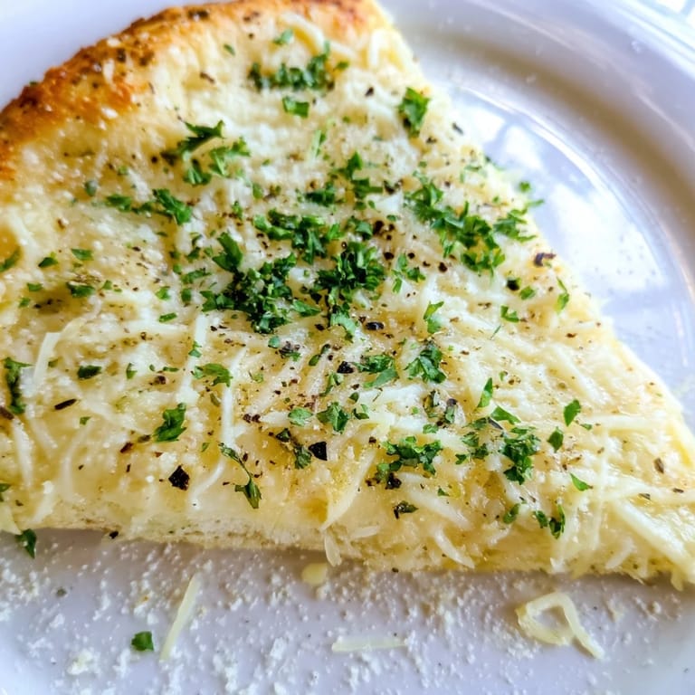 This Creamy Garlic White Pizza showcases a decadent garlic cream sauce under melted cheese.